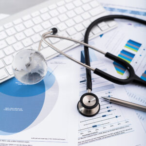 Stethoscope with financial statement on the desk.